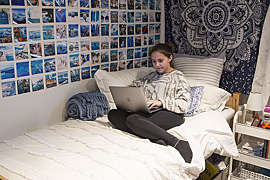 Girl Sitting on a Bed